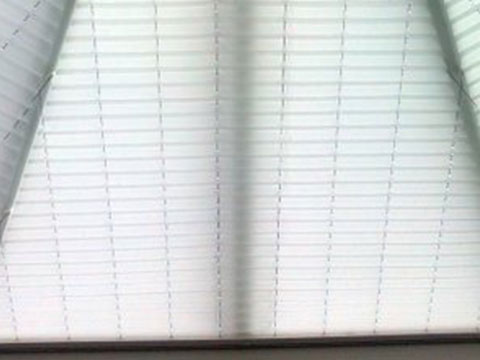 Pristine clean blinds with sunlight streaming through after service